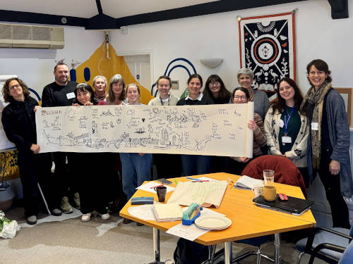 A group of people gather outside at North Street Gardens