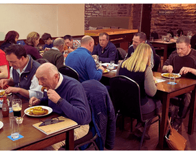 Farmers and landowners enjoying post presentation pie and peas