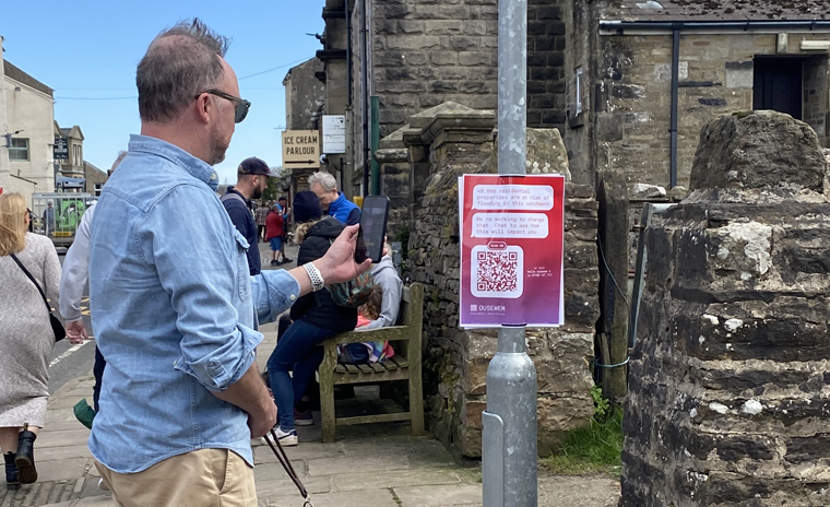 Resident engaging with Ousewem&rsquo;s friendly two-way conversations in Hawes, North Yorkshire, familiarising people with flood-related terminology and enhancing awareness about natural flood measures (NFM).