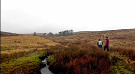 A still from the Artery video showing the North Yorkshire landscape and 2 people walking