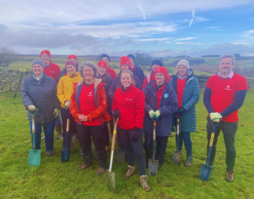 The Ousewem team and volunteers stood together in a field